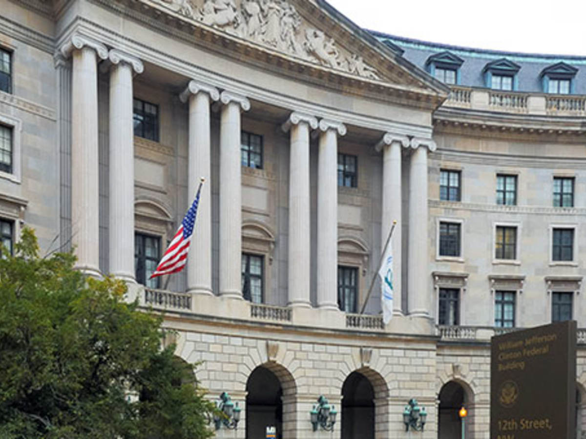 Pillared building with American flag flying from it