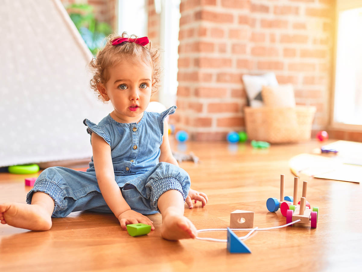 Child playing with wooden toys