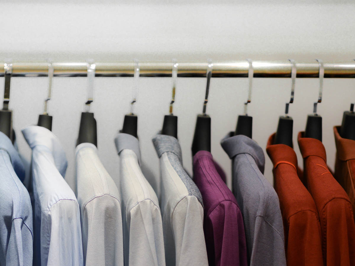 Close-Up Of Colorful Clothes Hanging On Rack At Store