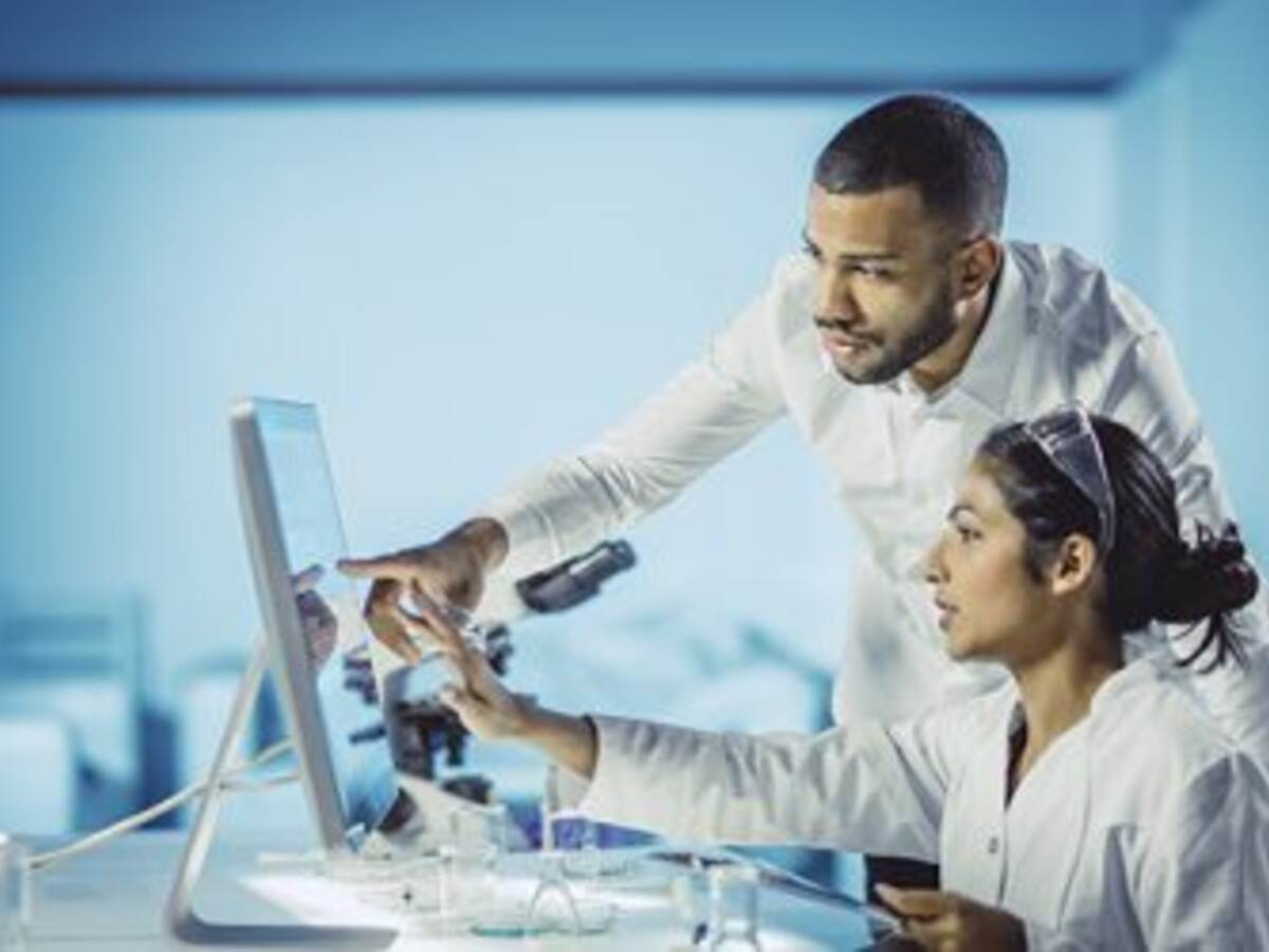 Scientists looking at computer 