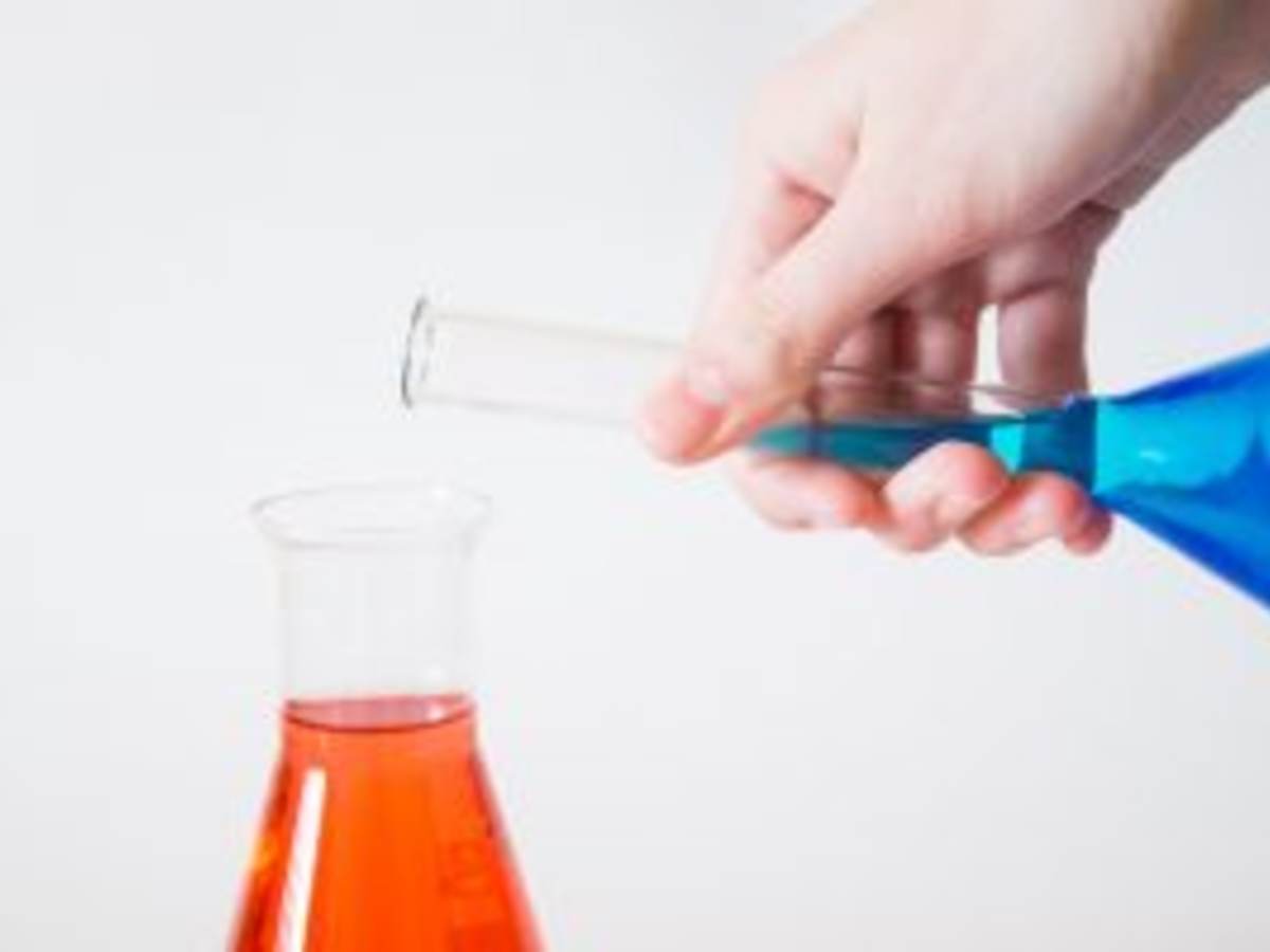 Blue vial being poured into orange vial.