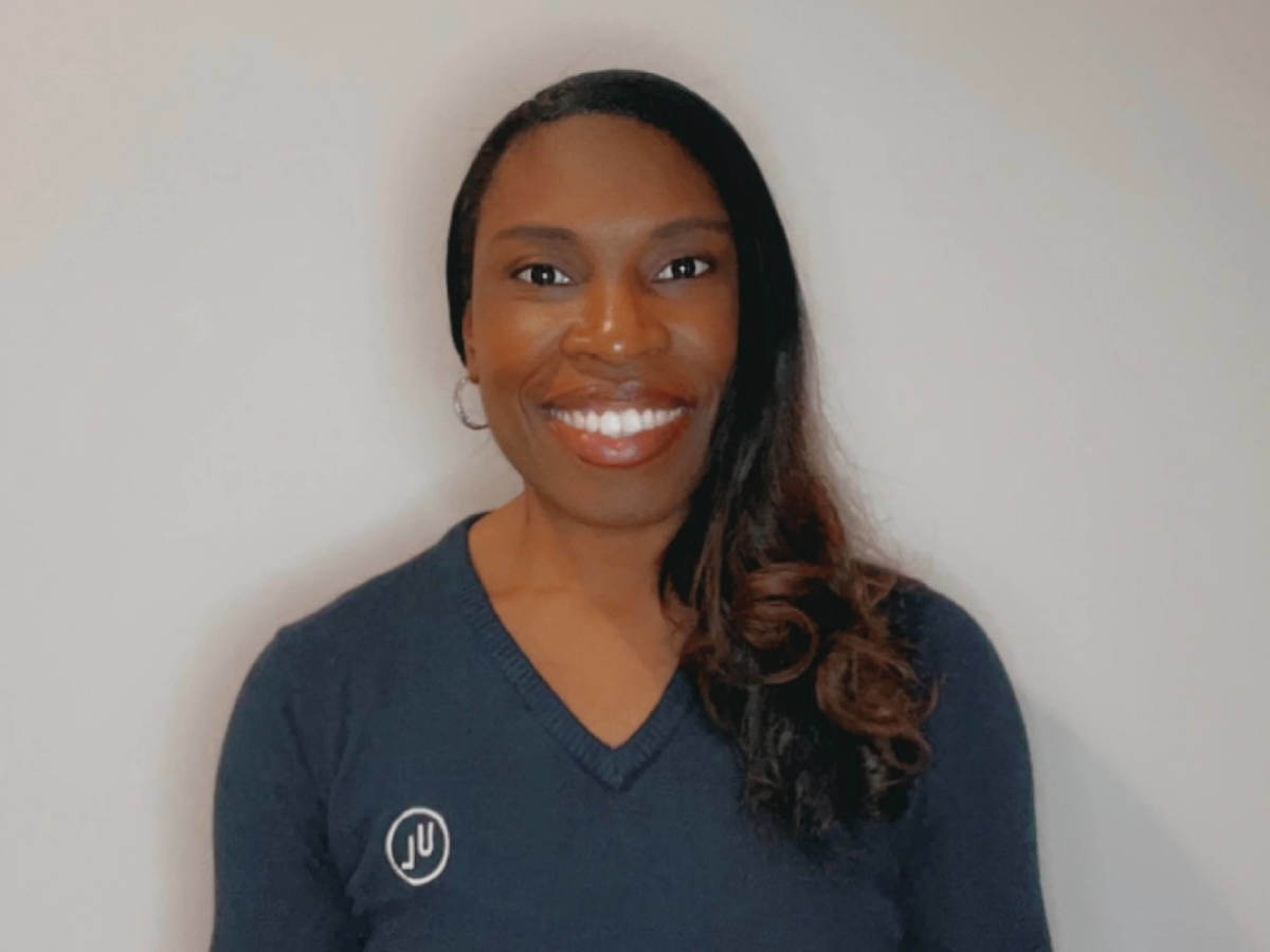 Denice Durrant smiles proudly in a beautiful blue sweater.