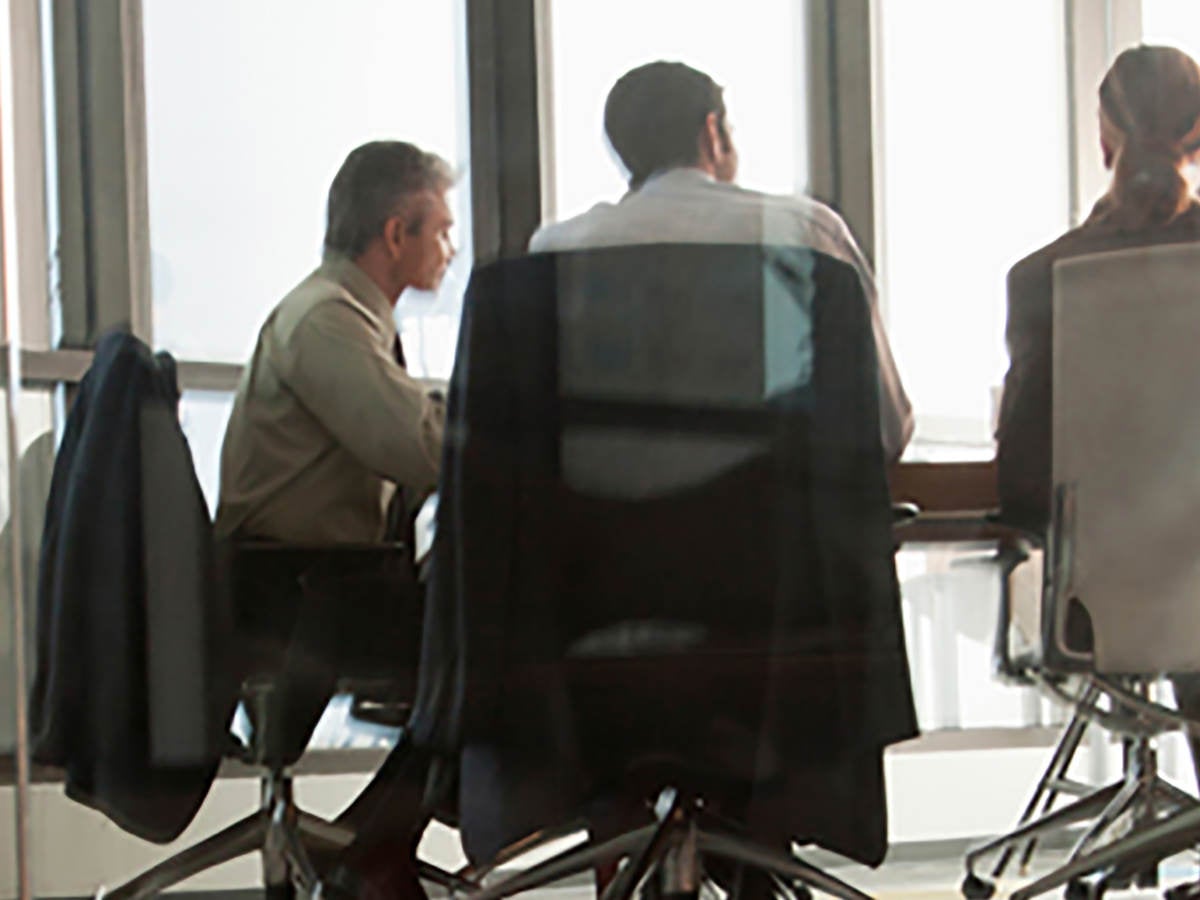 Business people in a modern all glass made meeting room