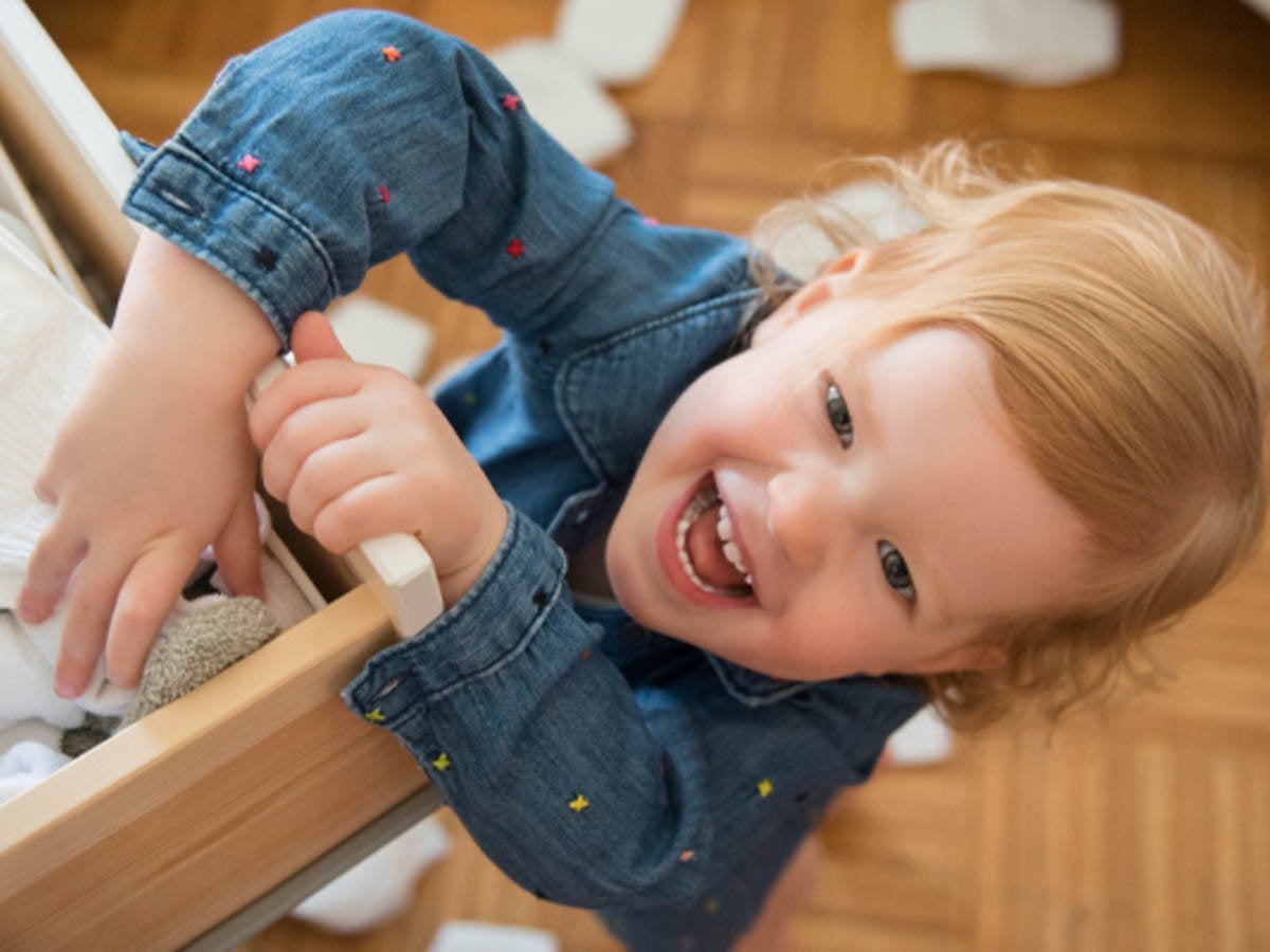Child pulling on a dresser drawer