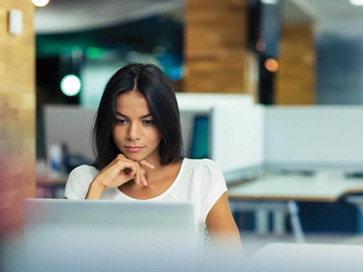 Woman reading content on a laptop screen