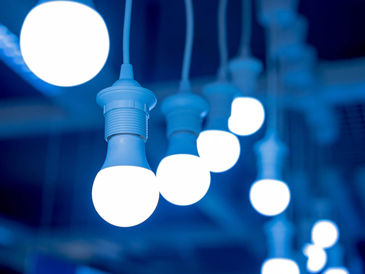 LED lightbulbs hanging from ceiling with blue background