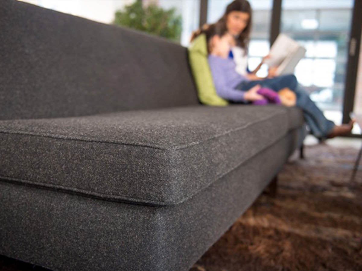 Mother and child sitting at the end of a sofa