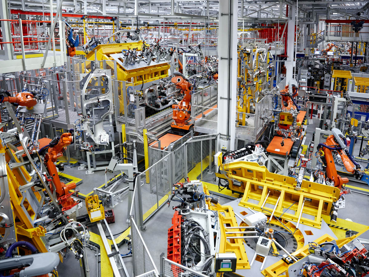 Robots putting cars together in a factory