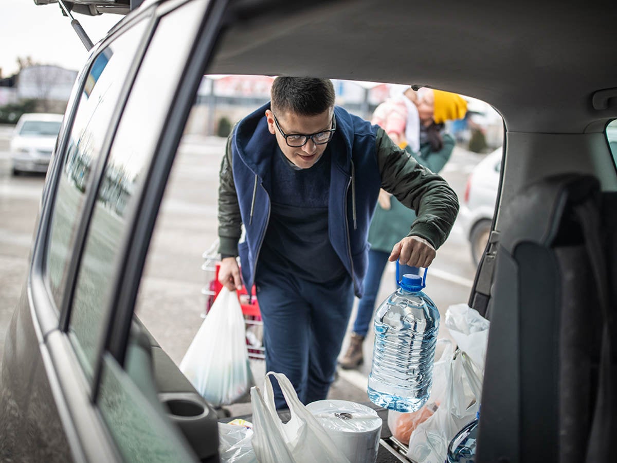 Man loading groceries into trunk