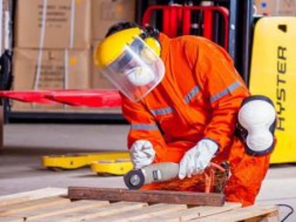 Industrial worker using grinder