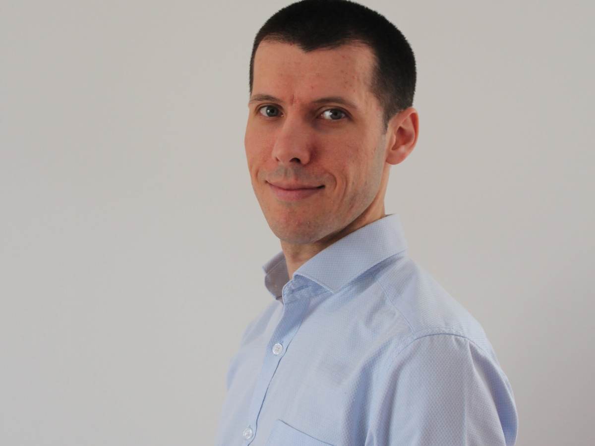 Headshot of Pierre-Marie Doitrand, standing at an angle and wearinga light blue button down shirt