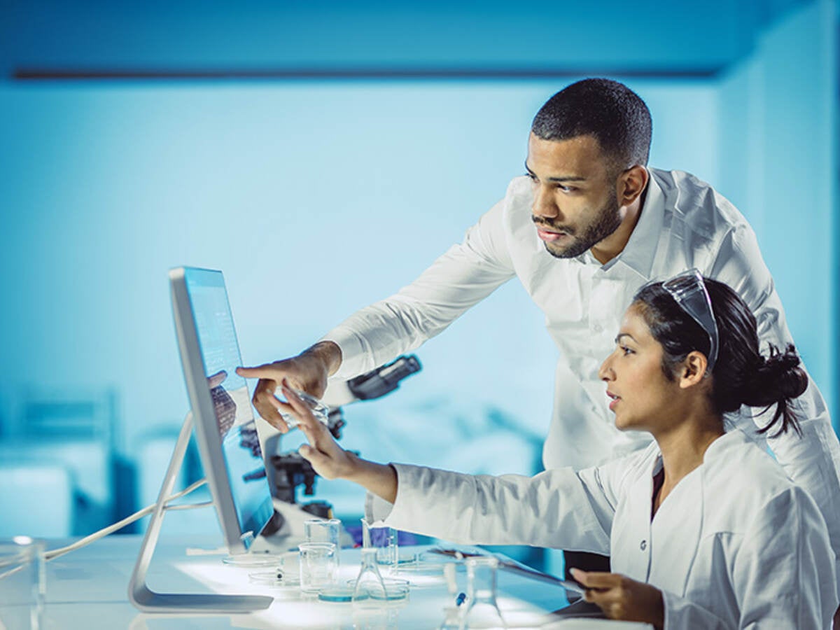 Scientists looking at computer