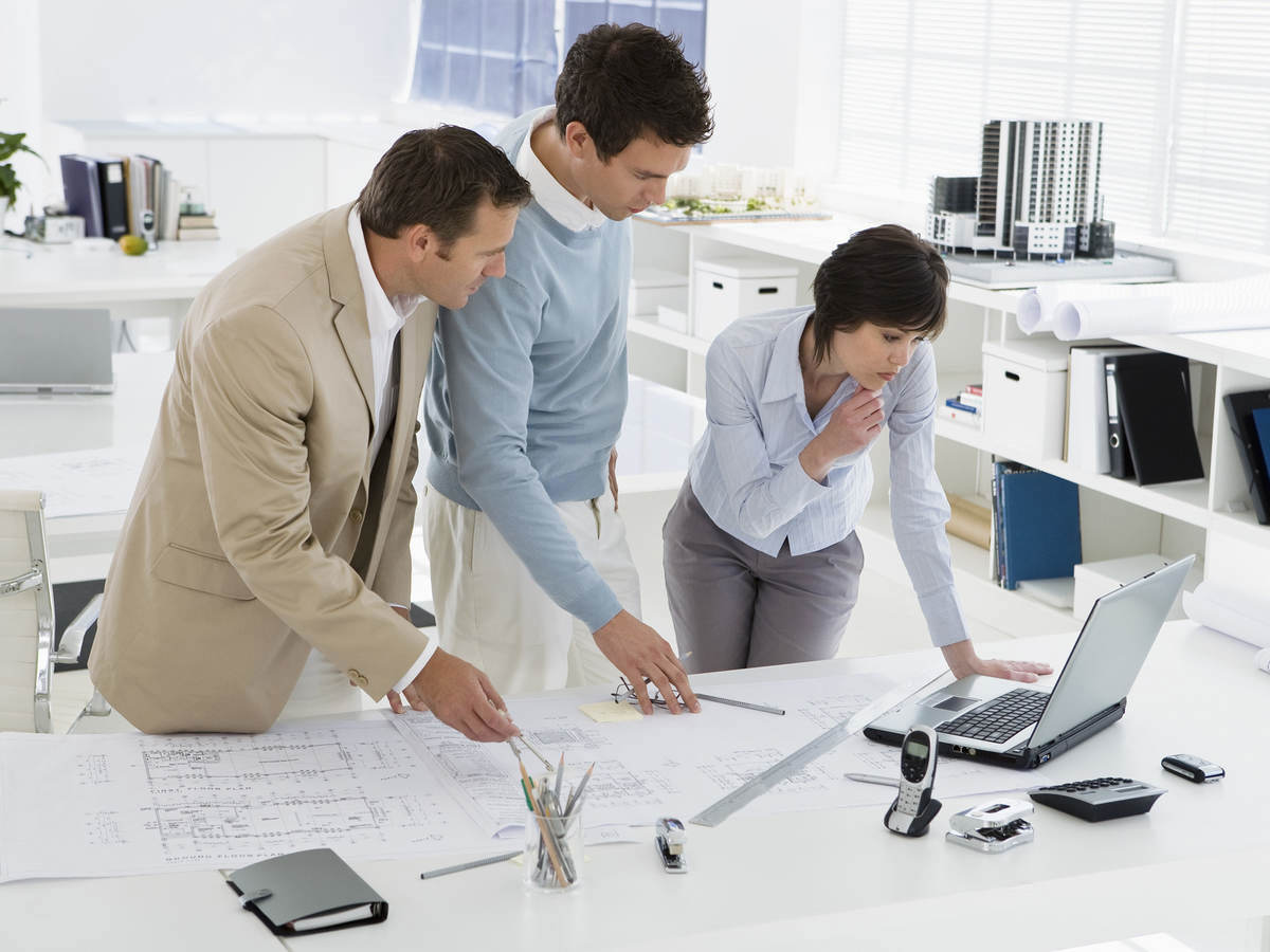 Work teammates looking at a laptop