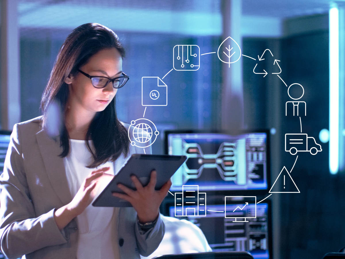 Female scientist sitting in front of computer screens
