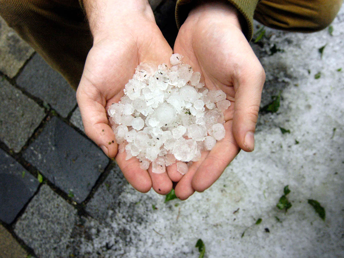 Two hands holding hail stones