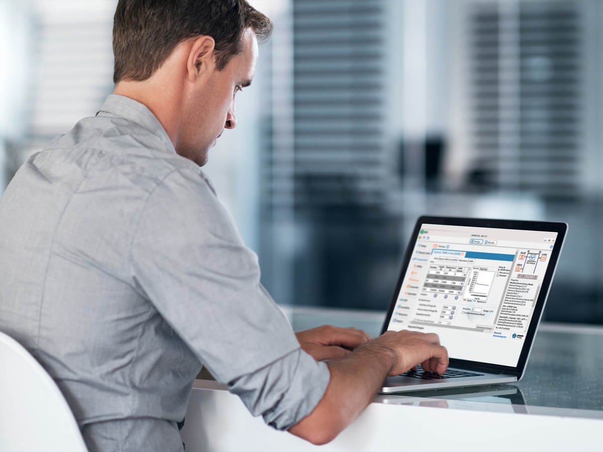 HOMER Grid microgrid software on a laptop with a man seated at a desk. 