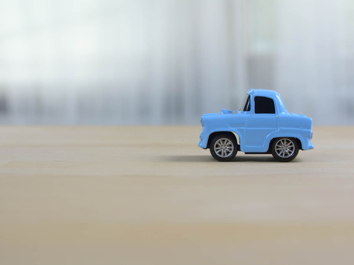 Blue old style toy car on a table