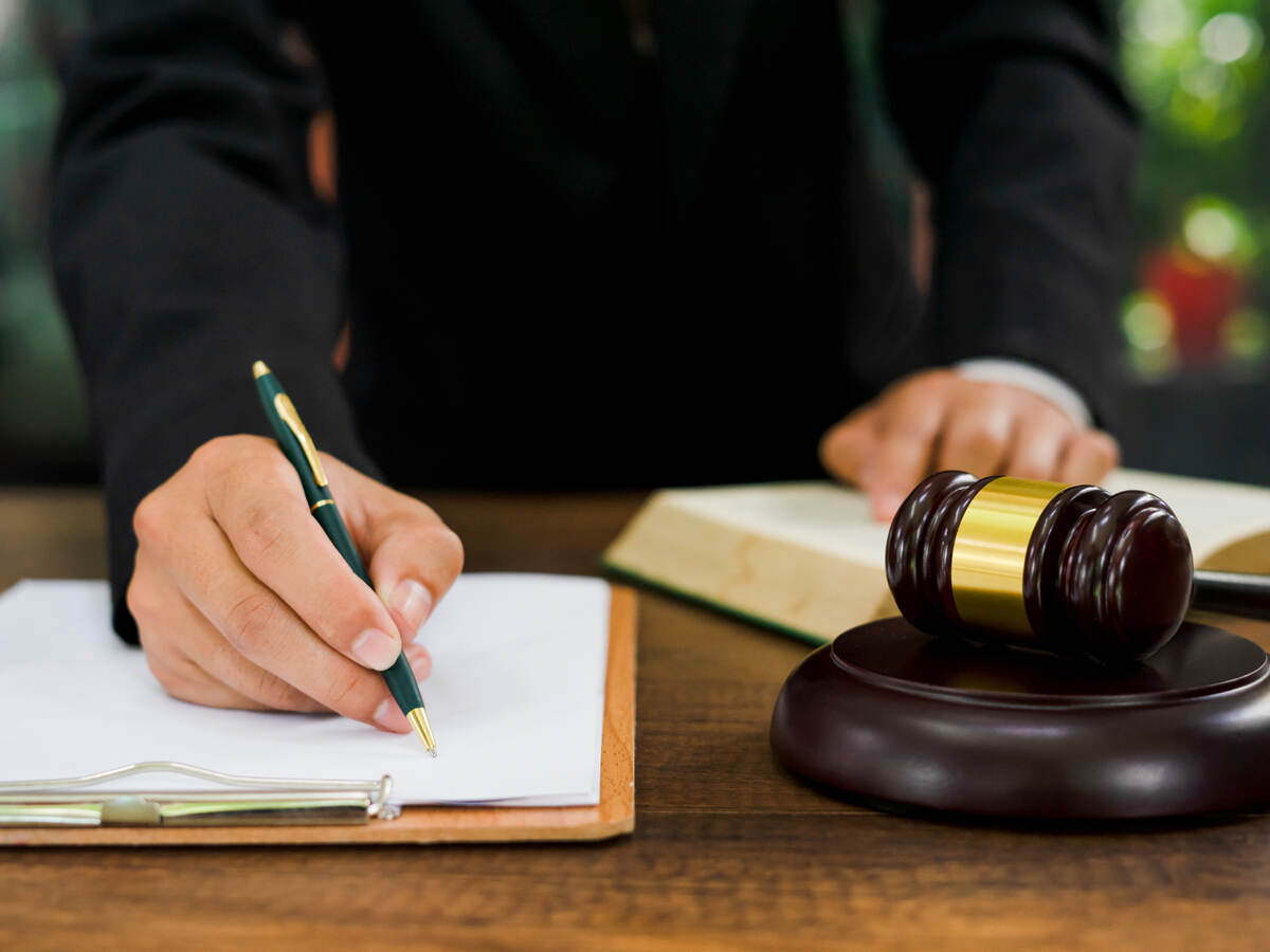 Man signing legal document