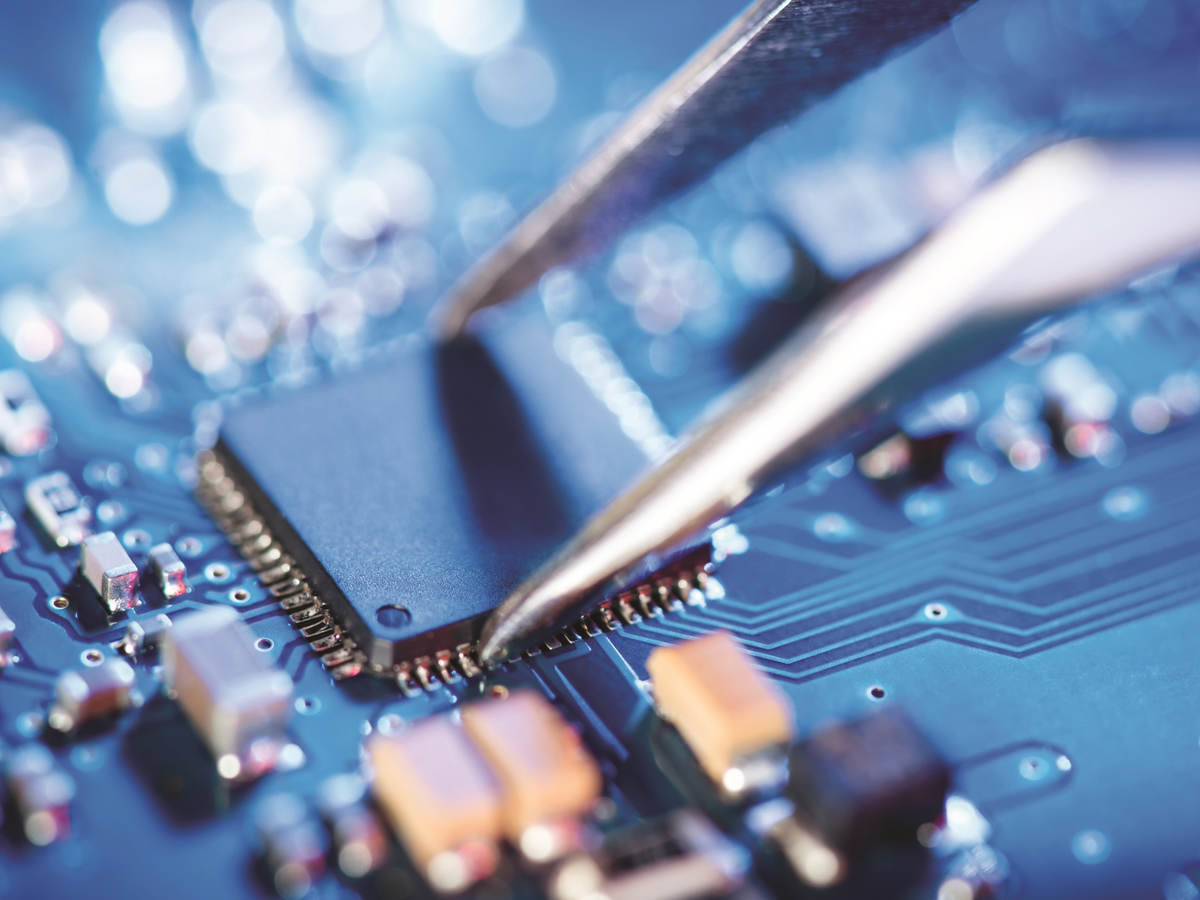 Tweezer being used on a circuit board