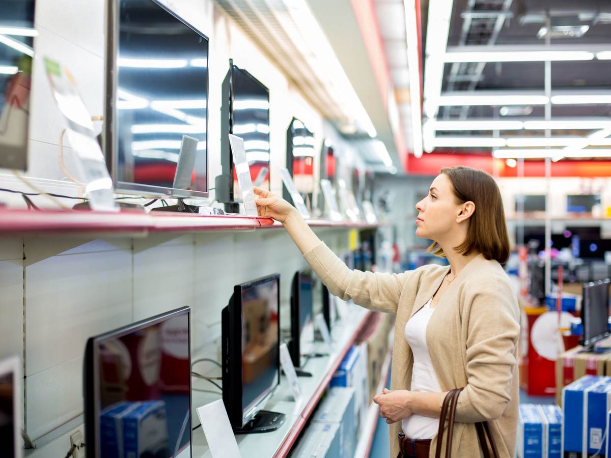woman buying a TV in a retail store