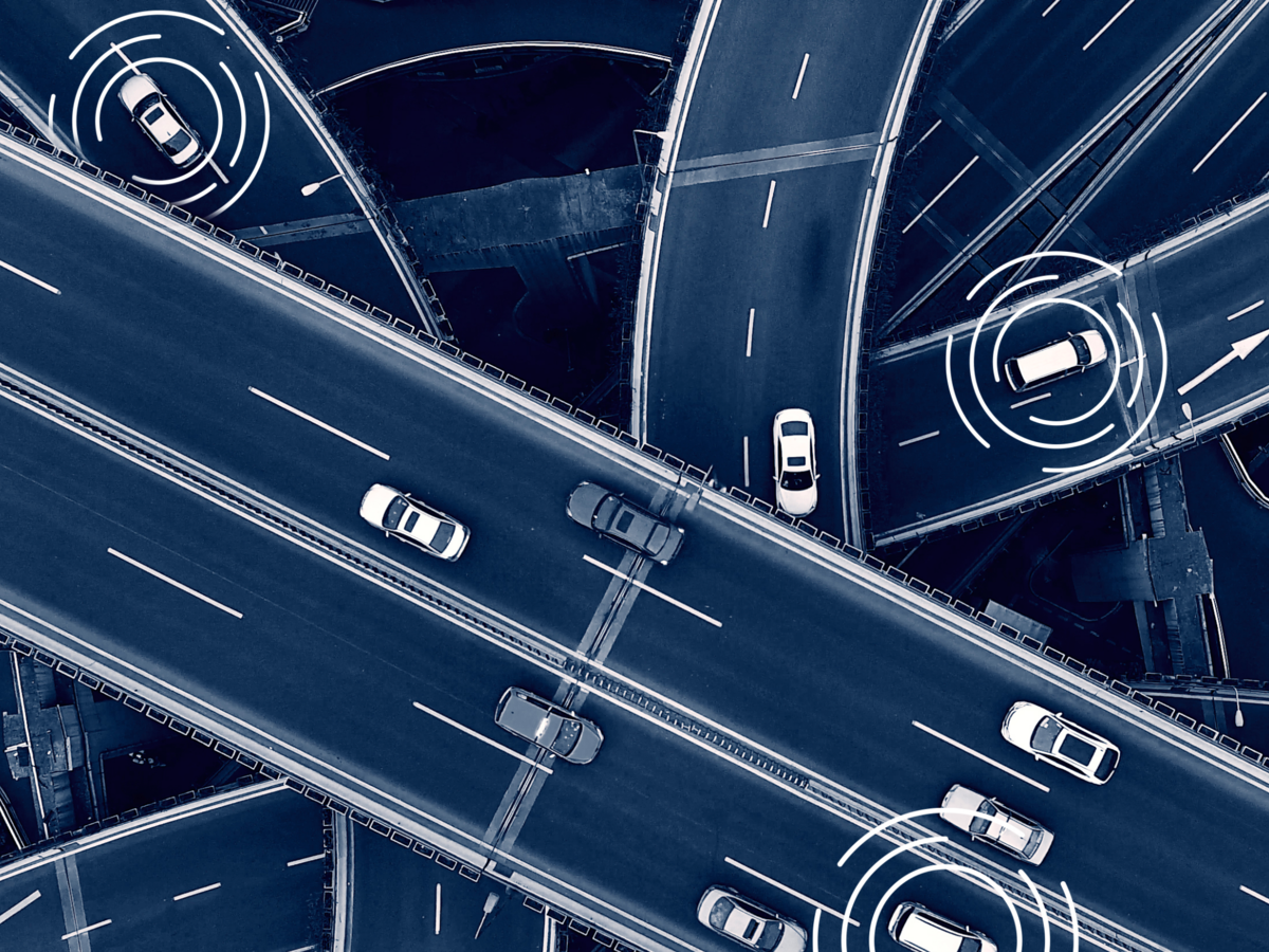 Close -up of a car driving in a city at dusk