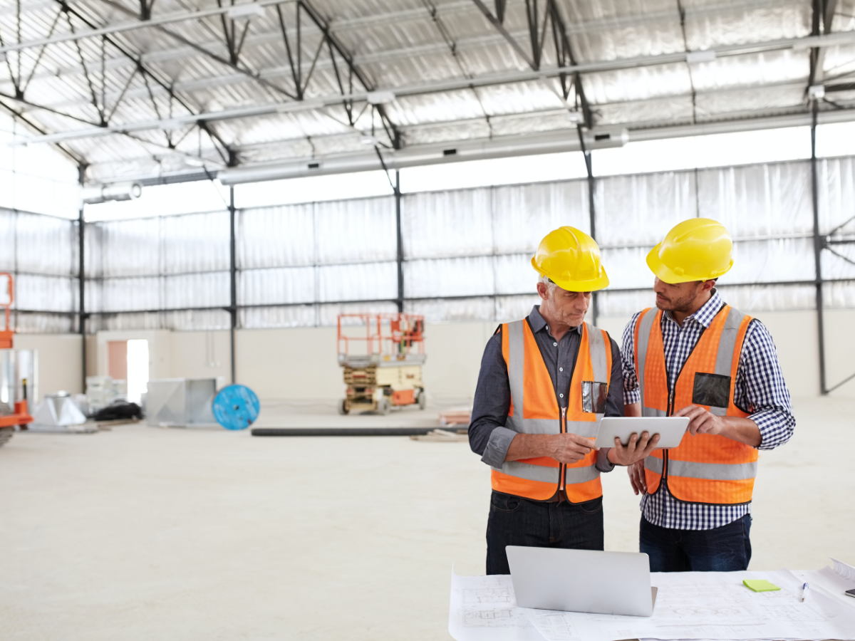 Two construction workers wearing safety gear