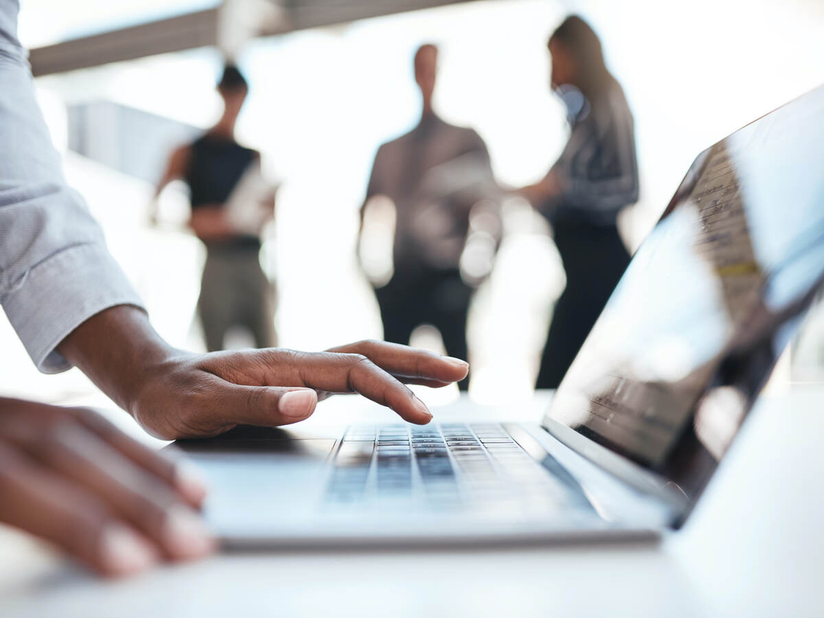 man typing on laptop keyboard