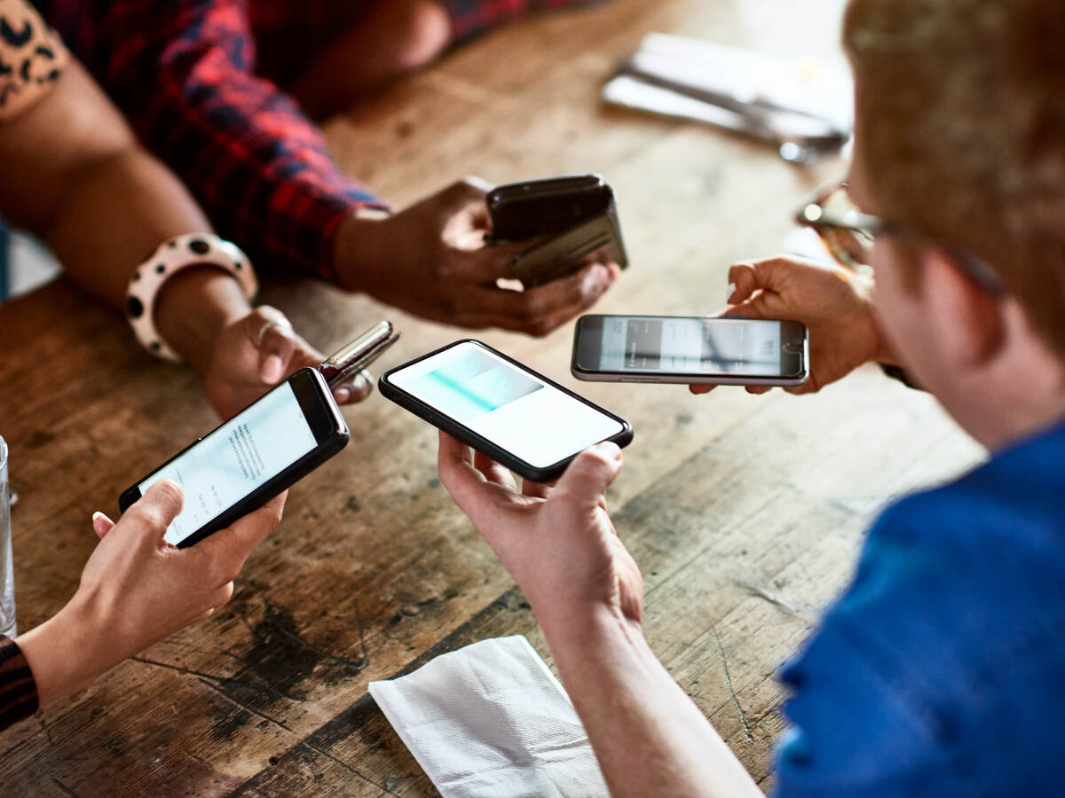 people sharing information by mobile phones