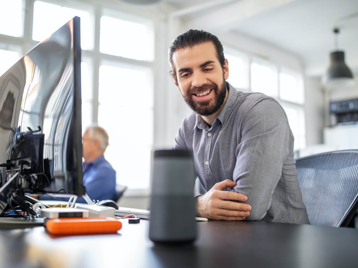 businessman using digital speaker at office