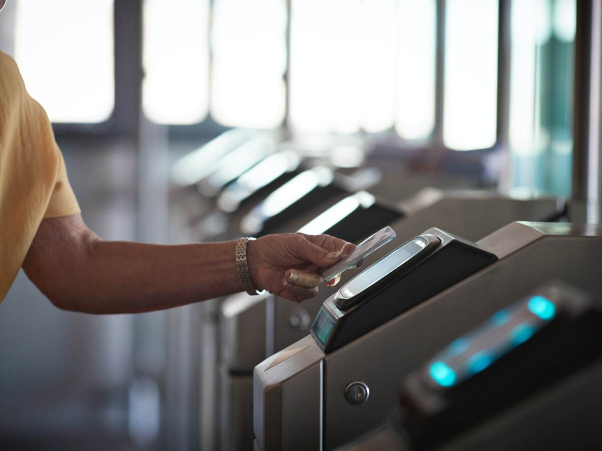 man tapping a card to open the gate