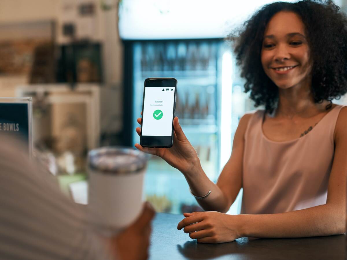 woman holding a mobile phone for payment
