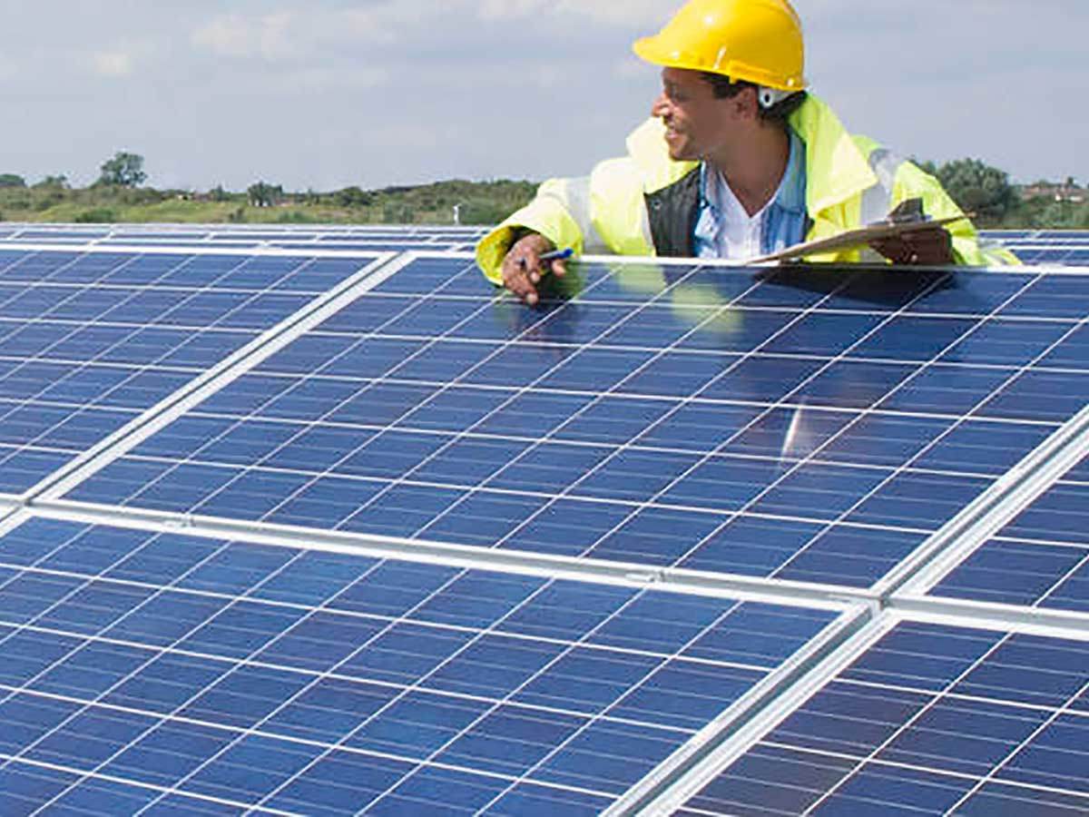 Renewables worker measuring solar panels