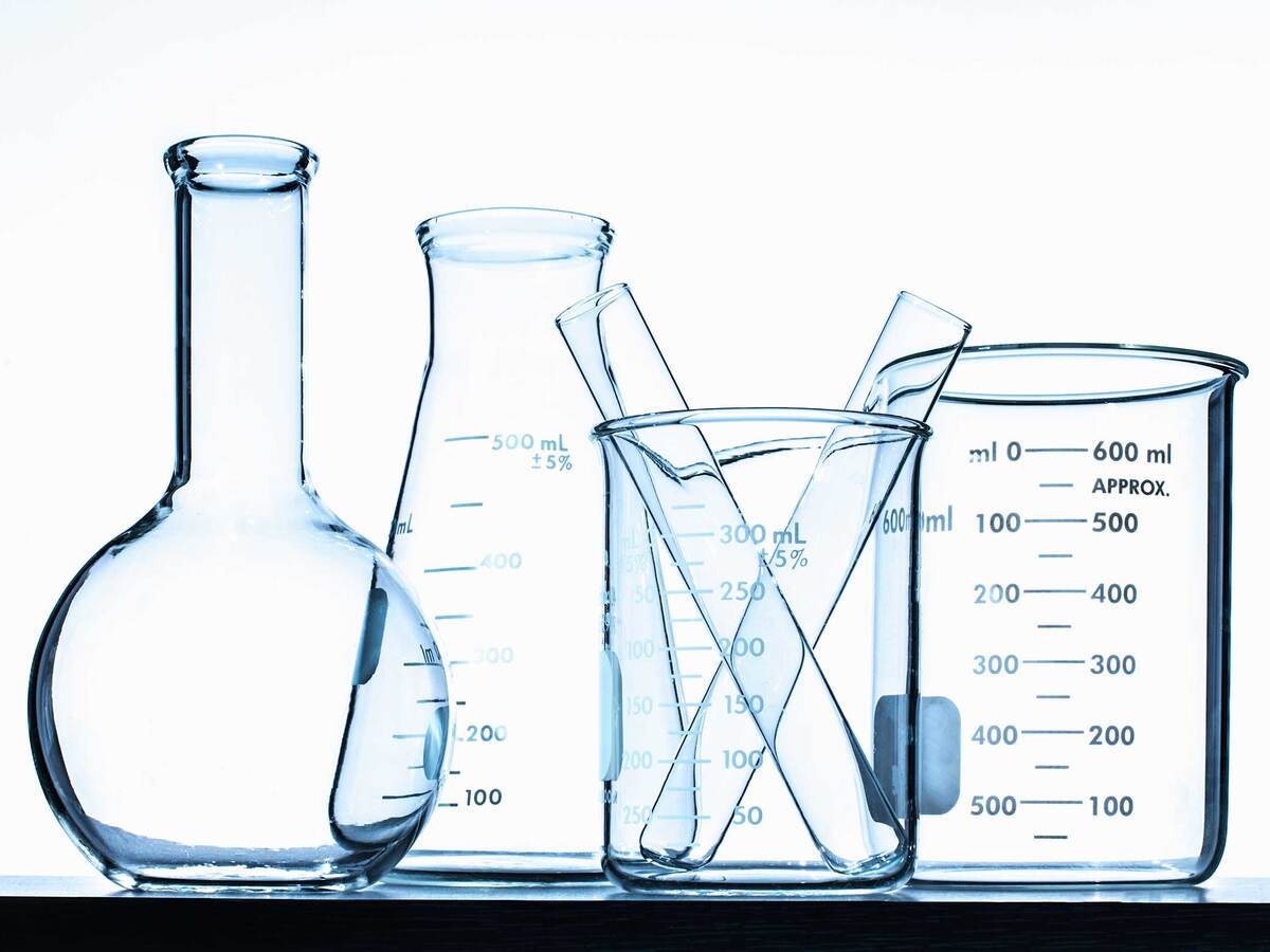 several empty glass beakers in a row