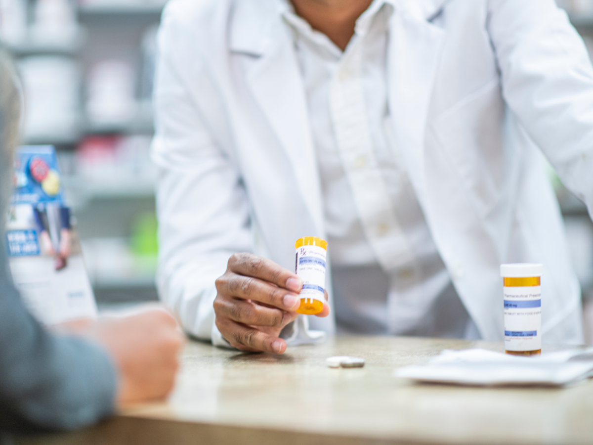 Pharmacist speaks with patient about prescription medication