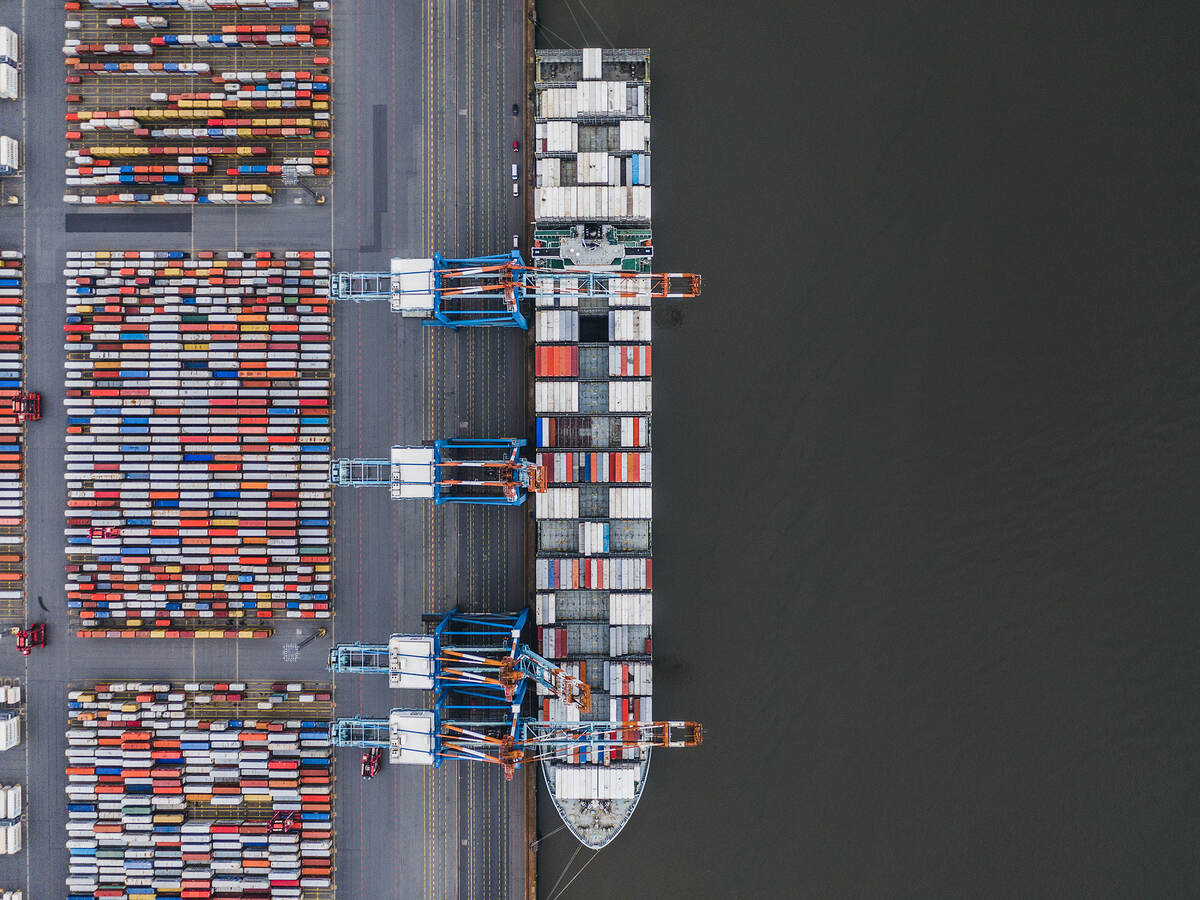 Container ship docked in port as seen from above