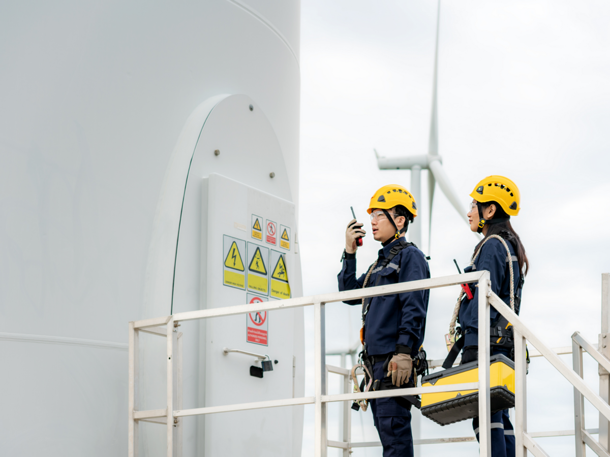 Employees performing a wind turbine inspection
