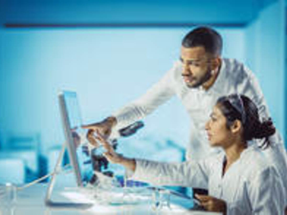 Scientists looking at a computer