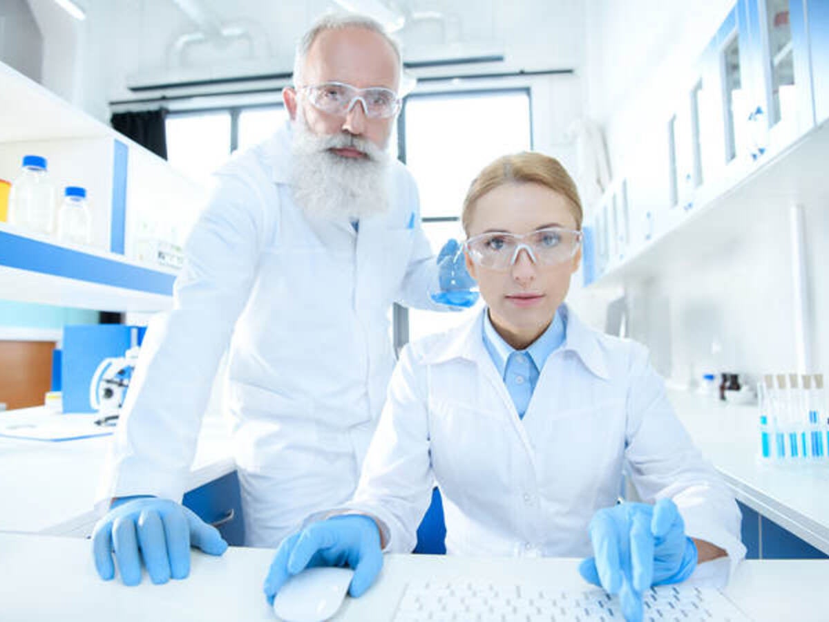 Scientists looking at a computer