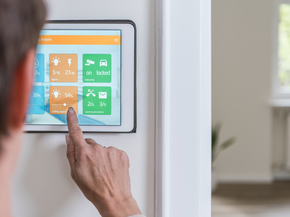 Woman operating touchscreen for smart home operation