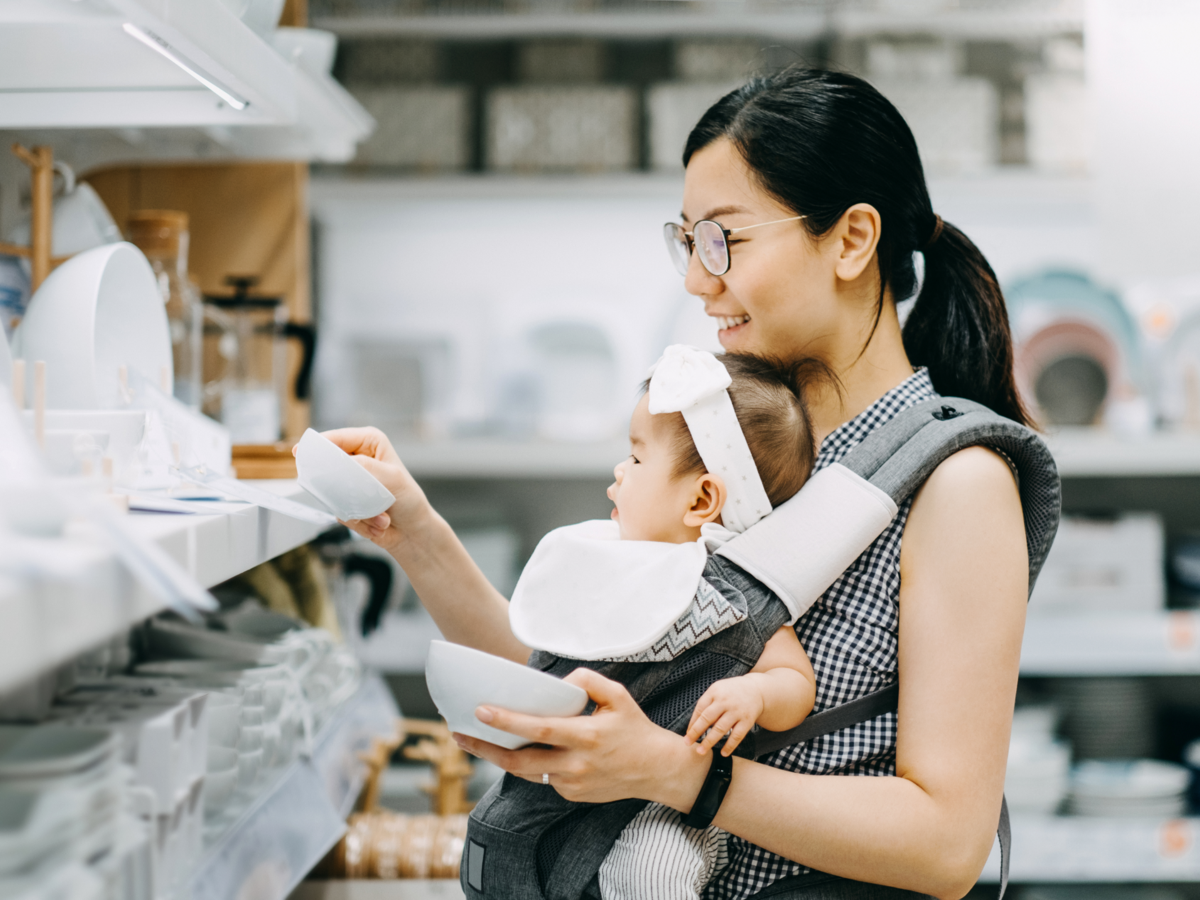 Woman shopping for dishes with her baby