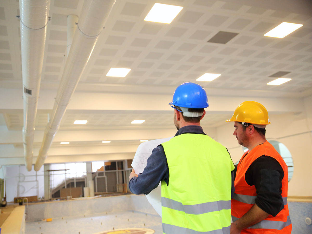two architects looking at warehouse floorplans