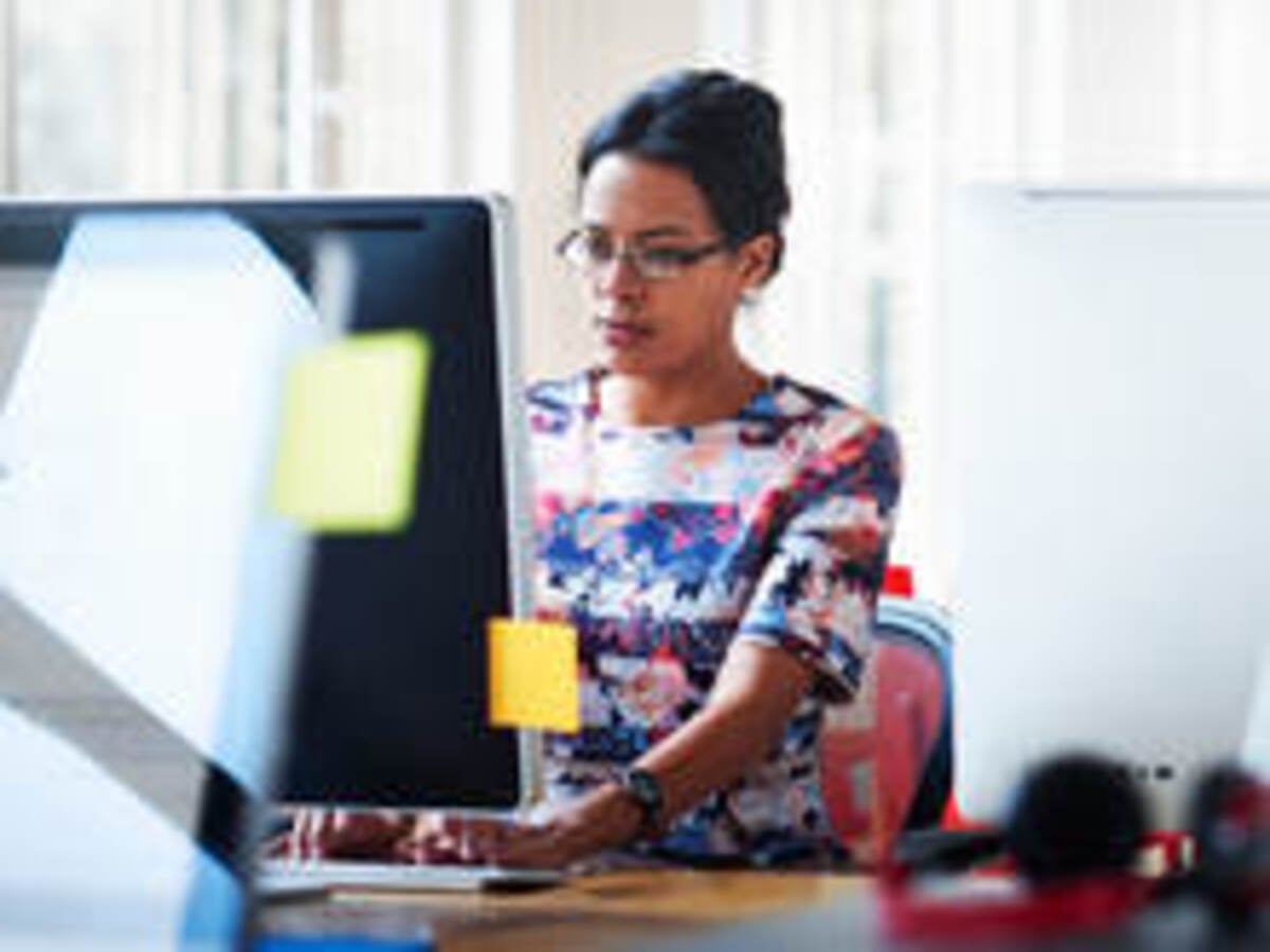 Woman reading news on a computer screen