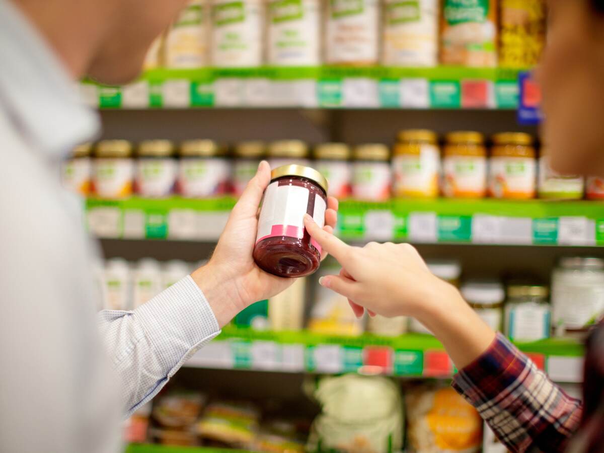 Woman holding jar at grocery store