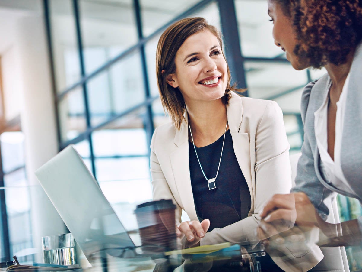Shot of two young businesswomen using a laptop together at work