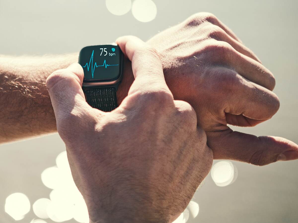 Man checking heart rate on a smart watch