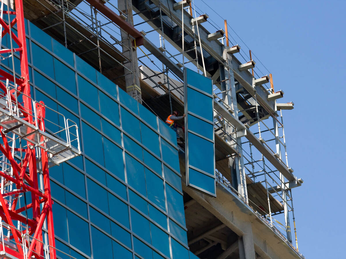 Lifting glass into place while constructing a commercial building