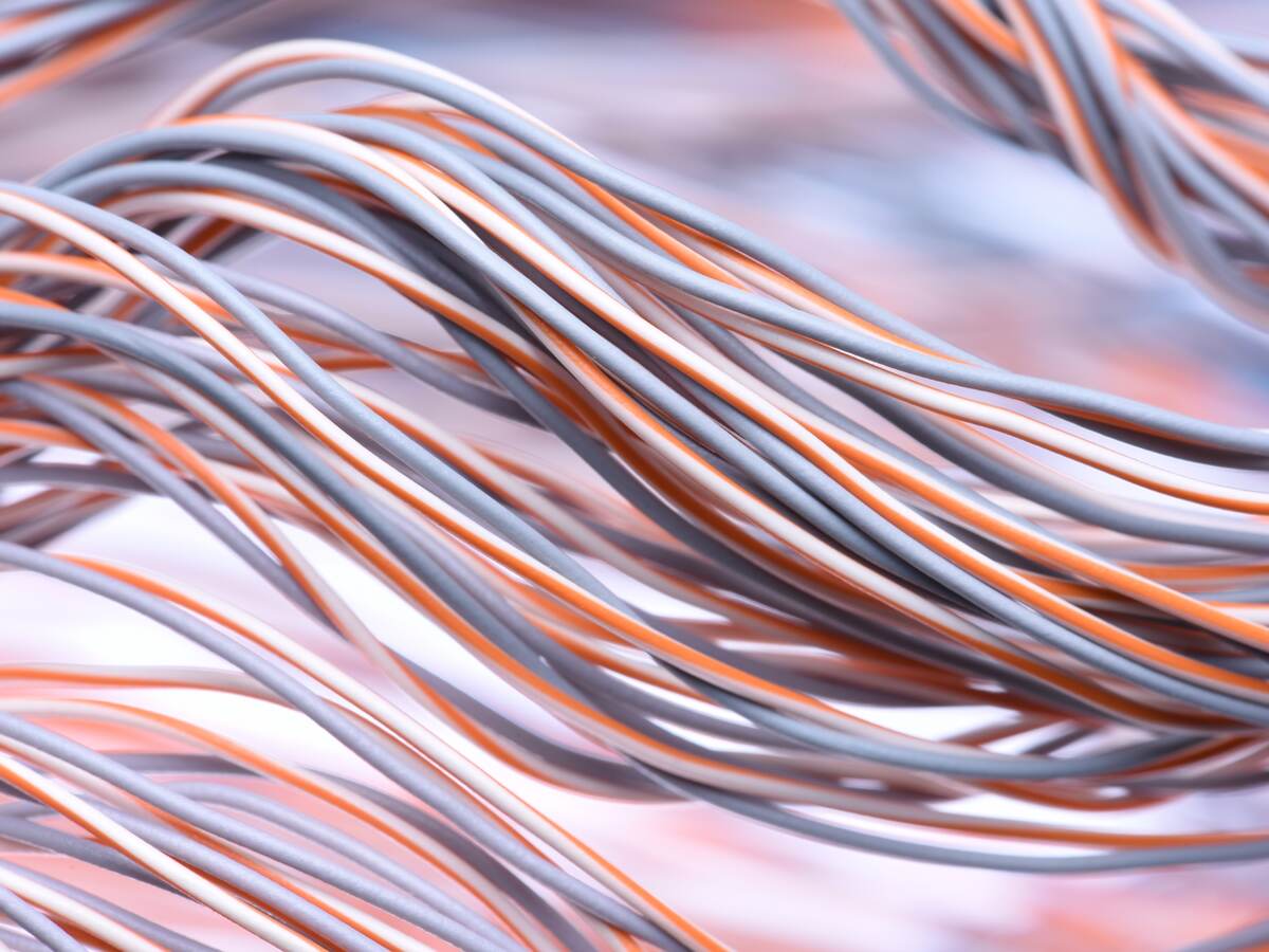 A closeup look at a swirl of electric cables and wires.