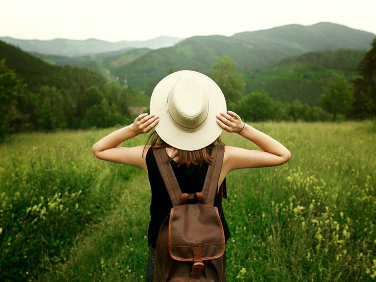 Woman traveler with backpack in nature