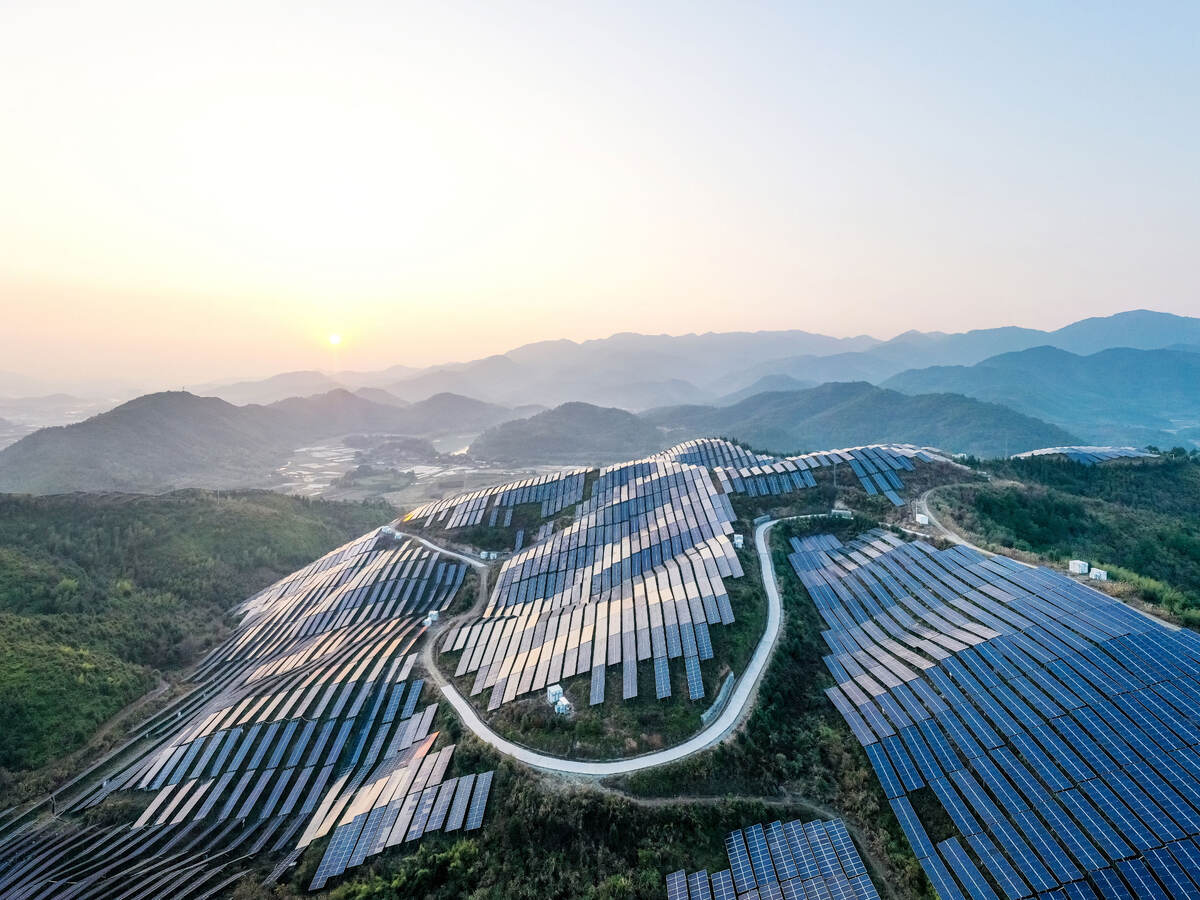 Aerial view of a solar power plant on top of a mountain.