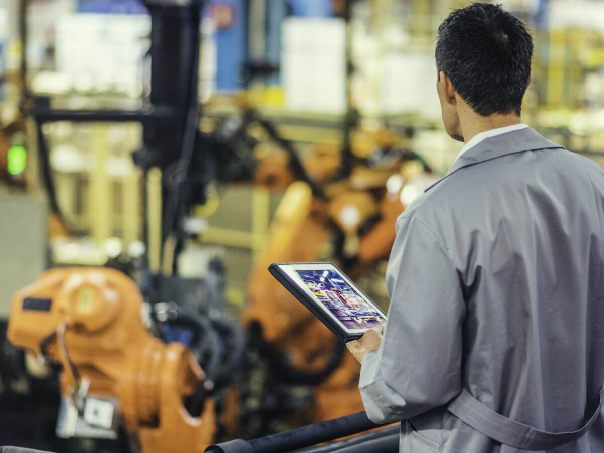 Engineer supervising robotic assembly line